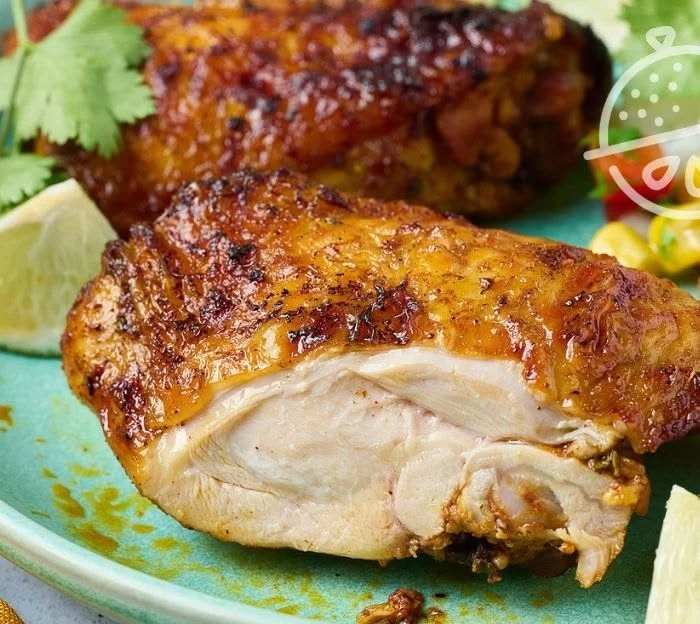 Deliciously roasted pollo asado served with vibrant sides and garnishes.