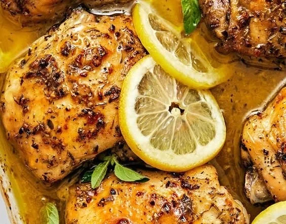 Plate of delicious Lemon Chicken garnished with herbs and lemon slices