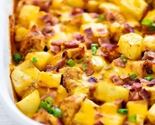 Loaded chicken and potato casserole topped with cheese and herbs.