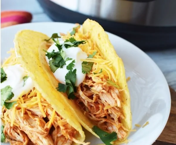 Pressure cooker chicken tacos served with fresh toppings