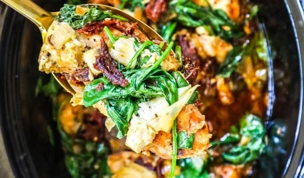 Slow Cooker Tuscan Chicken with herbs and vegetables in a bowl